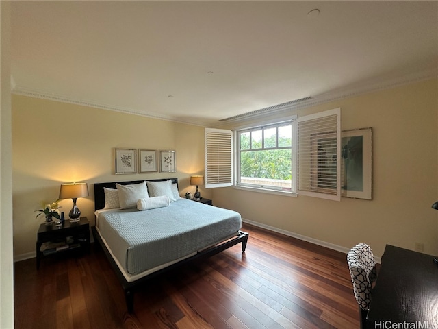 bedroom featuring crown molding and dark hardwood / wood-style flooring