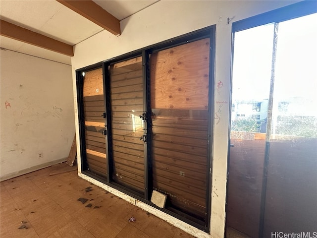 doorway with beamed ceiling