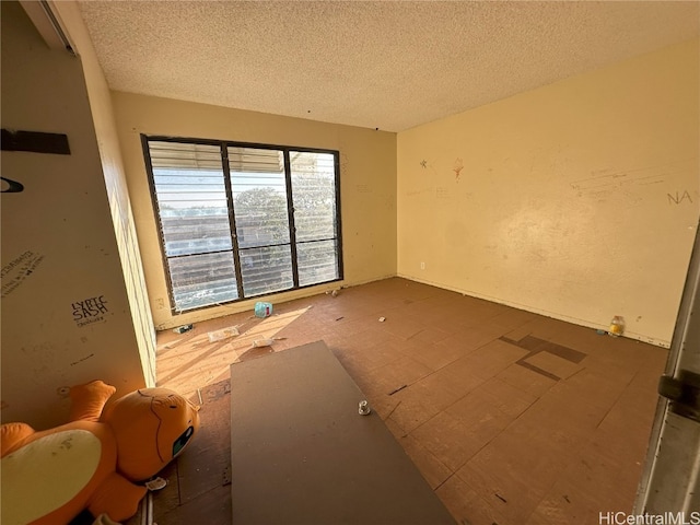 spare room featuring a textured ceiling