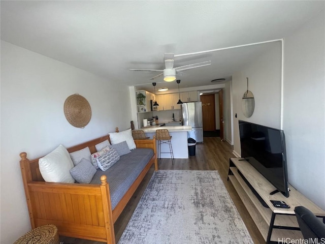 living room with ceiling fan and dark wood-type flooring