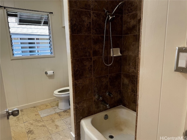 bathroom featuring toilet and tiled shower / bath combo