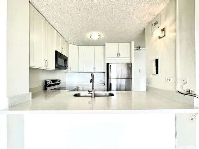 kitchen with white cabinets, kitchen peninsula, sink, and appliances with stainless steel finishes