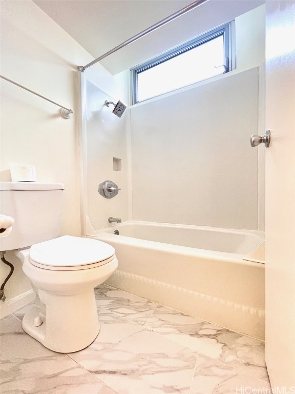 bathroom featuring shower / bathtub combination and toilet