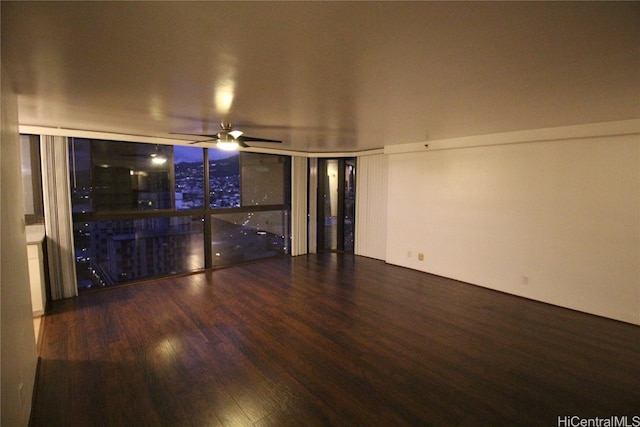 unfurnished living room with ceiling fan and wood-type flooring