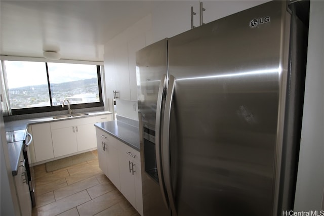 kitchen with white cabinetry, white range oven, sink, and stainless steel fridge with ice dispenser