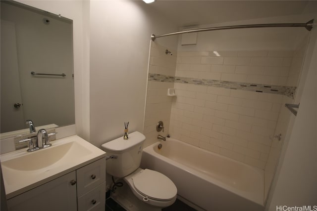 full bathroom featuring toilet, tiled shower / bath, and vanity