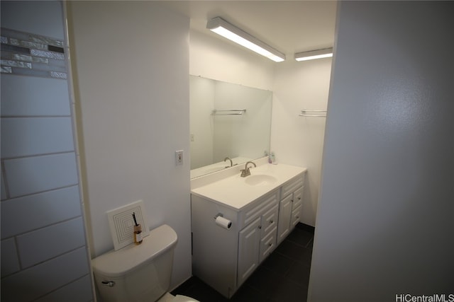 bathroom featuring vanity, toilet, and tile patterned flooring