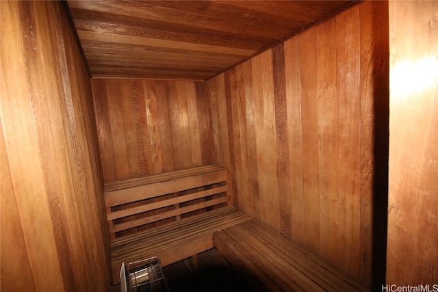 view of sauna with wood ceiling and wood walls