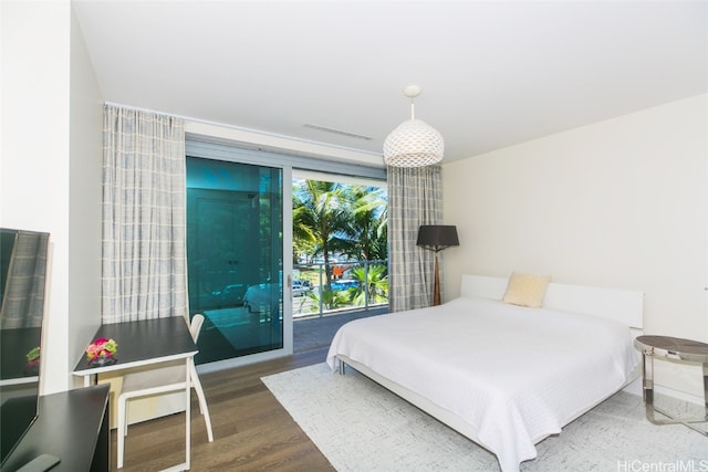 bedroom featuring access to exterior and hardwood / wood-style floors