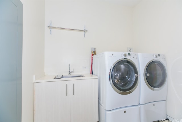 laundry area with cabinets, sink, and washing machine and clothes dryer