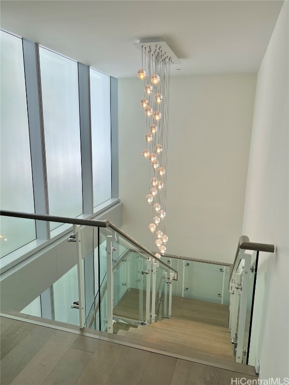 stairway with hardwood / wood-style flooring and a wealth of natural light