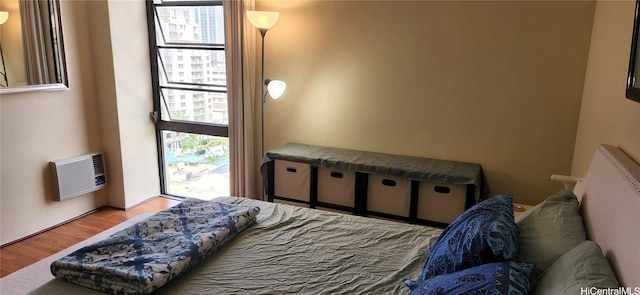 2410 Cleghorn St Unit 1504, Honolulu, HI 96815 - bedroom featuring wood finished floors and a wall unit AC