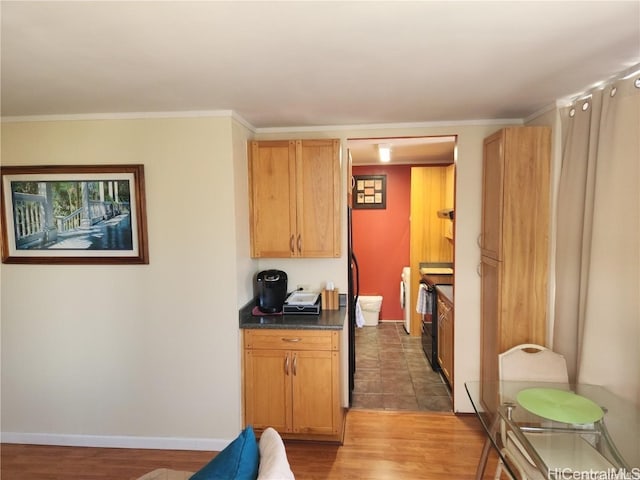 kitchen featuring crown molding, electric range, and dark hardwood / wood-style flooring