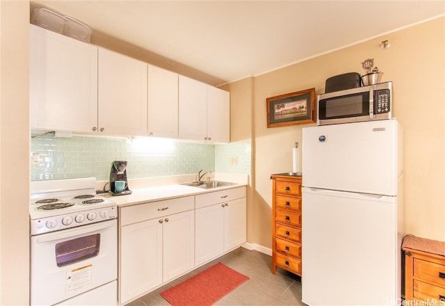 kitchen featuring decorative backsplash, white cabinetry, sink, and white appliances