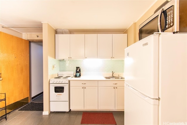 kitchen with decorative backsplash, white cabinets, sink, and white appliances