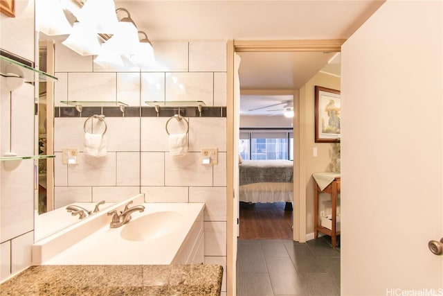 bathroom with vanity, hardwood / wood-style floors, tile walls, and ceiling fan