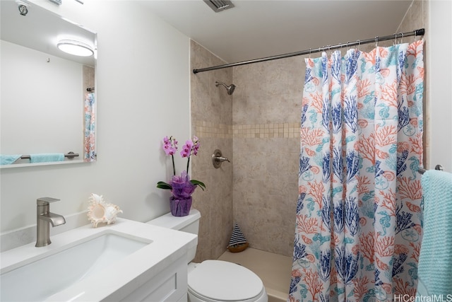 bathroom with vanity, curtained shower, and toilet