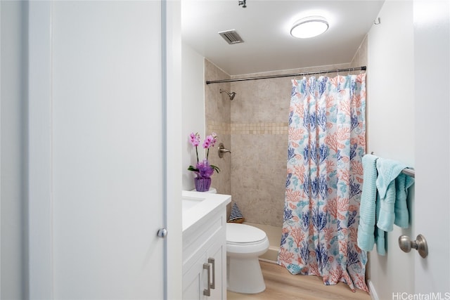 bathroom featuring vanity, a shower with shower curtain, wood-type flooring, and toilet