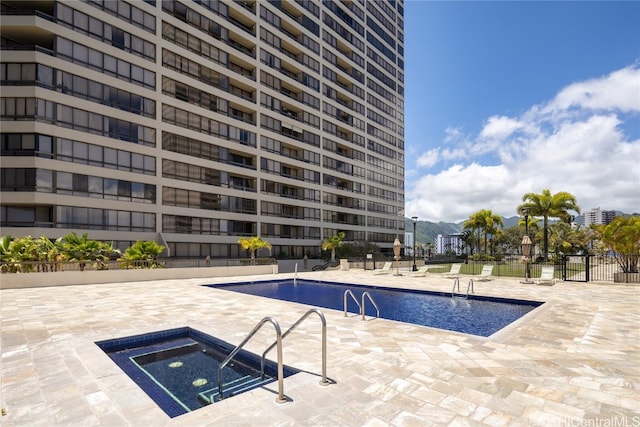 view of pool featuring a patio area and a community hot tub