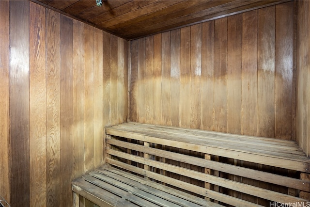 view of sauna with wooden walls and wooden ceiling