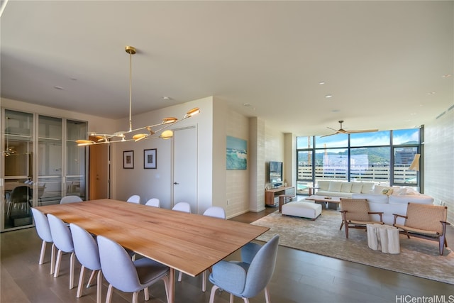 dining room featuring dark wood-type flooring and expansive windows