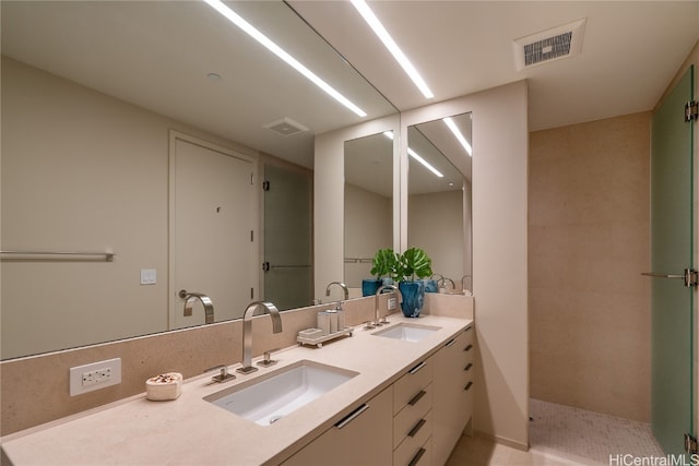 bathroom featuring vanity, tile patterned floors, and walk in shower