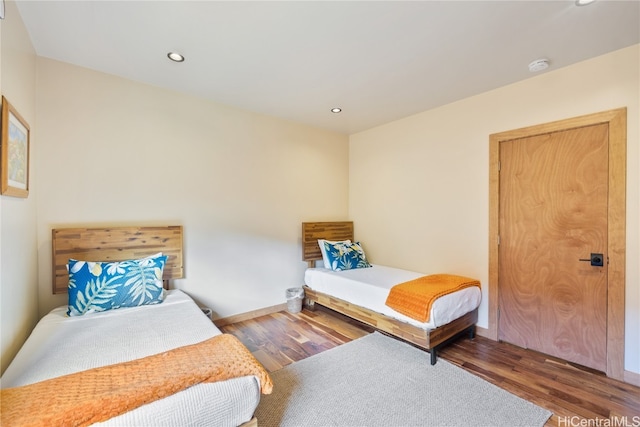 bedroom with dark wood-type flooring