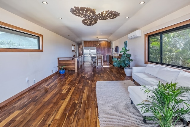 living room with a wall mounted air conditioner and dark hardwood / wood-style flooring