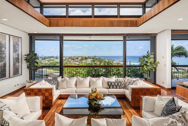 sunroom / solarium featuring a water view