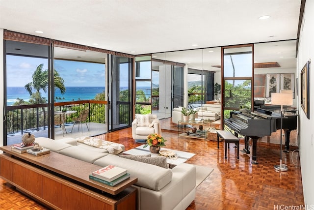 living room featuring expansive windows, a water view, and parquet floors