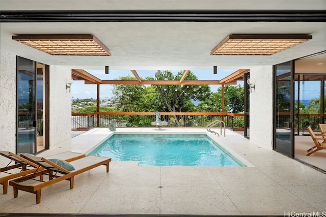 view of swimming pool featuring a patio area