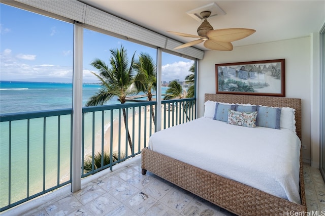 bedroom with a water view, ceiling fan, access to outside, and a view of the beach