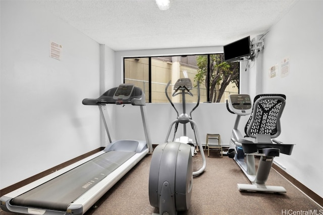 workout room featuring a textured ceiling