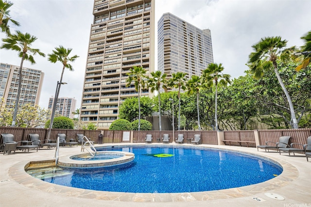 581 Kamoku St Unit 2402, Honolulu, HI 96826 - view of swimming pool with a patio area, fence, and a pool with connected hot tub