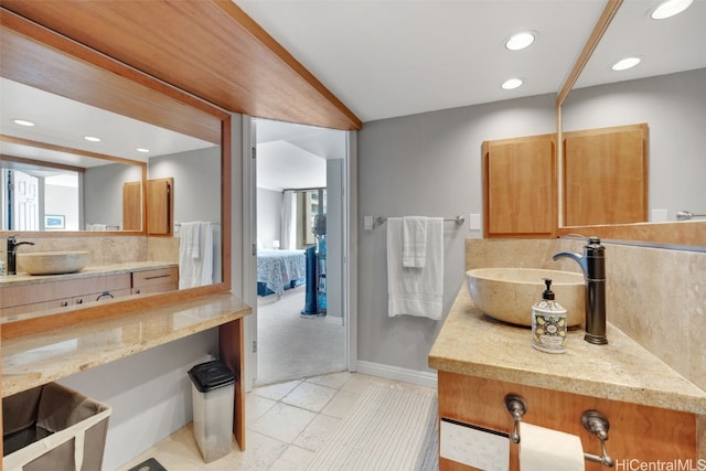 bathroom featuring vanity, tasteful backsplash, and tile patterned flooring