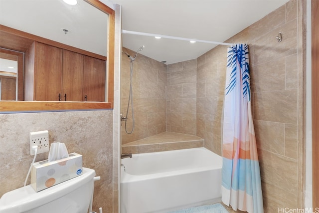 bathroom featuring toilet, tile walls, and shower / tub combo