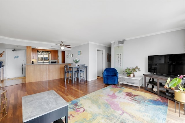 living room with crown molding, hardwood / wood-style flooring, and ceiling fan