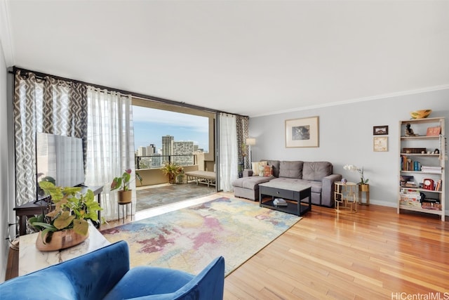 living room with wood-type flooring, ornamental molding, and floor to ceiling windows