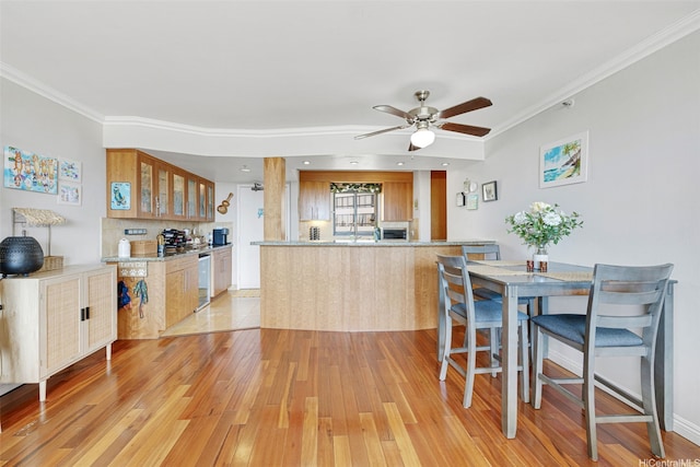 581 Kamoku St Unit 2402, Honolulu, HI 96826 - dining space with light wood-style floors, ornamental molding, and a ceiling fan