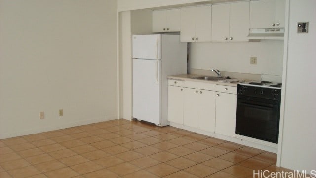 kitchen with sink, black / electric stove, light tile patterned flooring, white refrigerator, and white cabinets