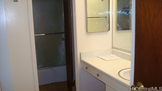 bathroom with vanity and bath / shower combo with glass door