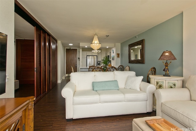 living room with a chandelier and dark wood-type flooring