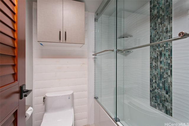 bathroom featuring toilet and enclosed tub / shower combo