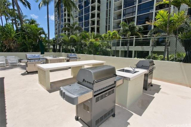 view of patio with an outdoor kitchen and a grill