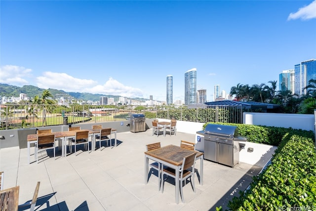 view of patio / terrace with area for grilling and a mountain view