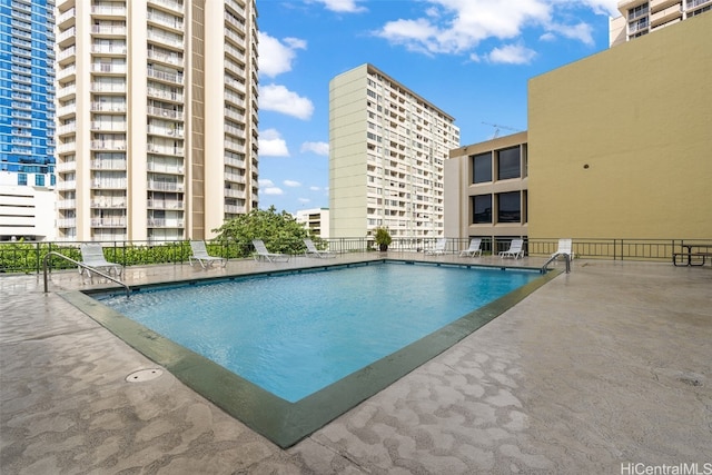 view of swimming pool featuring a patio area