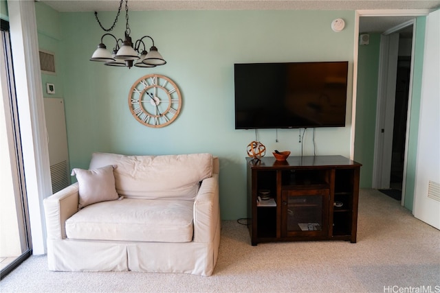 living room with a notable chandelier and carpet