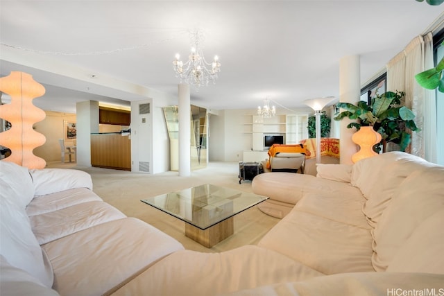 carpeted living room with a chandelier