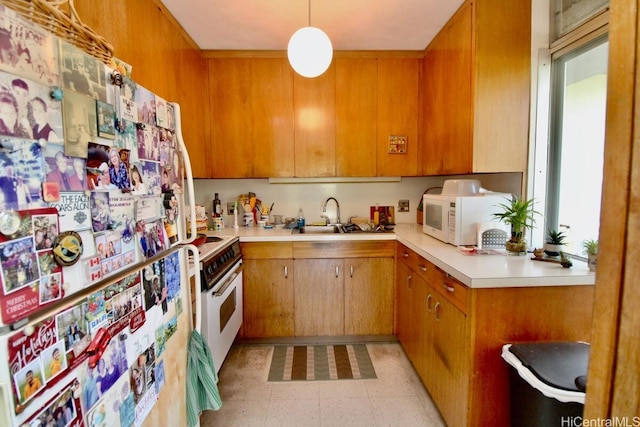 1511 Nuuanu Ave Unit 338, Honolulu, HI 96817 - kitchen featuring white appliances, light flooring, light countertops, a sink, and brown cabinets