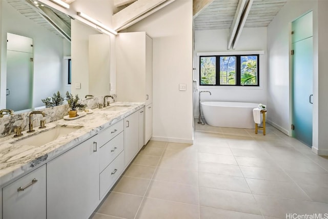 bathroom with lofted ceiling with beams, wooden ceiling, a tub, and vanity